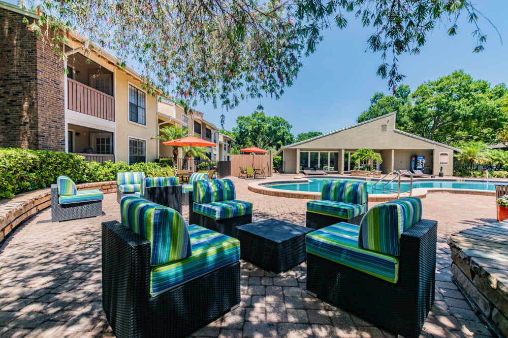 Comfortable patio furniture by the pool at Legend Oaks in Tampa, Florida