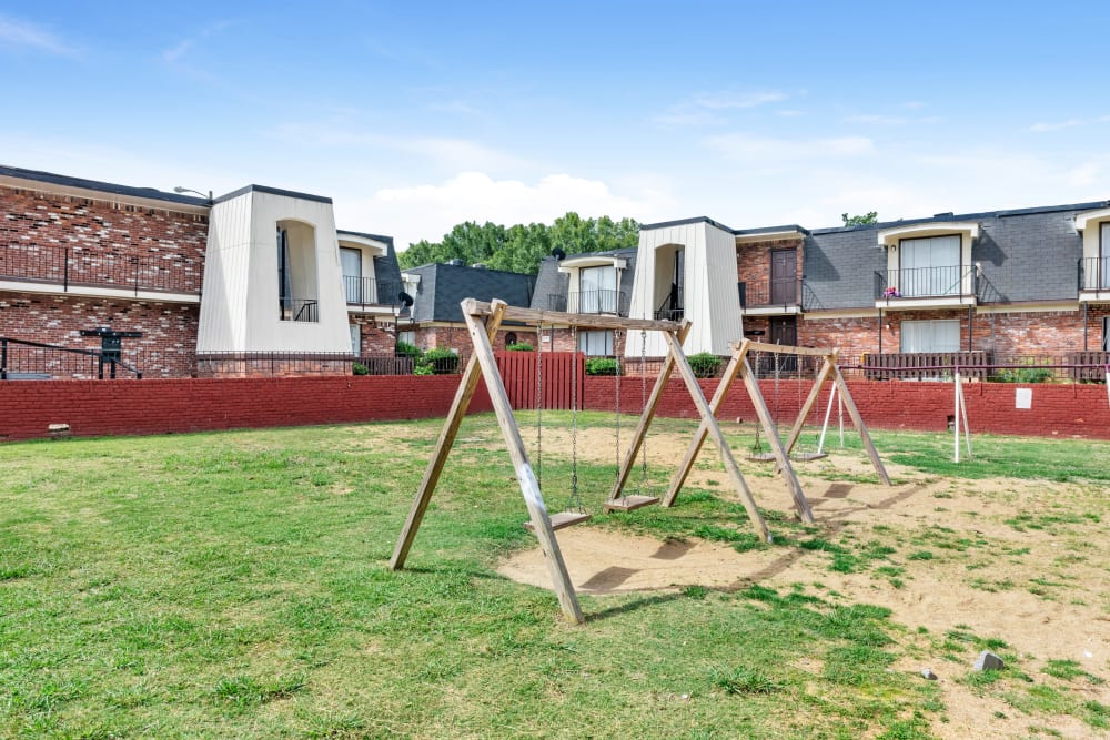 Outdoor swing sets for children at Cambridge Place Apartments in Montgomery, Alabama