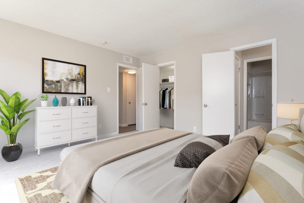 A furnished bedroom with an attached bedroom at Cambridge Place Apartments in Montgomery, Alabama