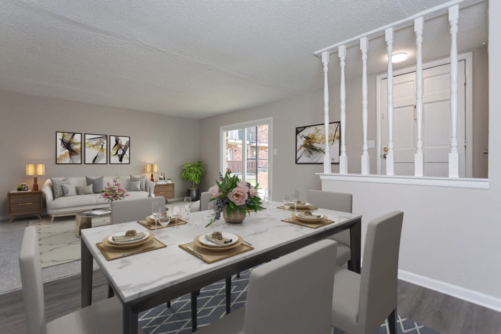 A dining room and living room at Cambridge Place Apartments in Montgomery, Alabama