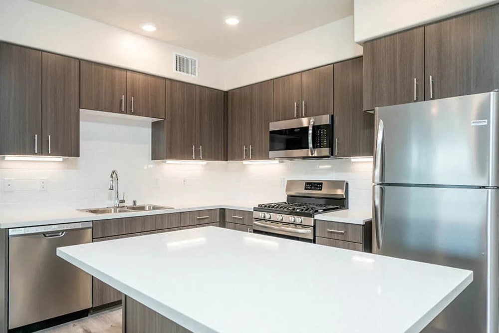 Kitchen with brown cabinets at Hub Apartments in Folsom, California