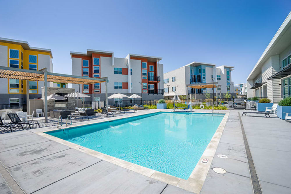 Deck chair around outdoor swimming pool at Hub Apartments in Folsom, California