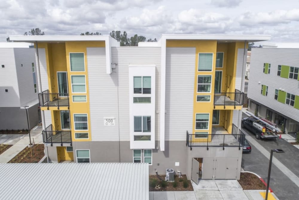 Exterior of an apartment with private patios and balconies at Hub Apartments in Folsom, California