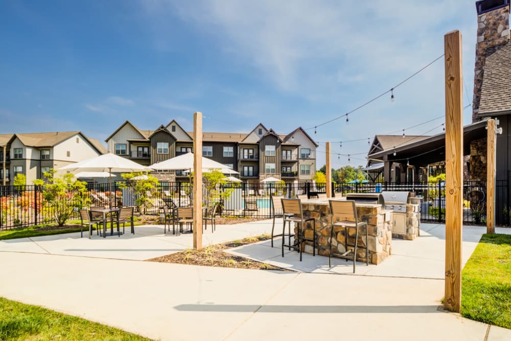 BBQ grilling area and outdoor seating at The Holston | Apartments in Weaverville, North Carolina