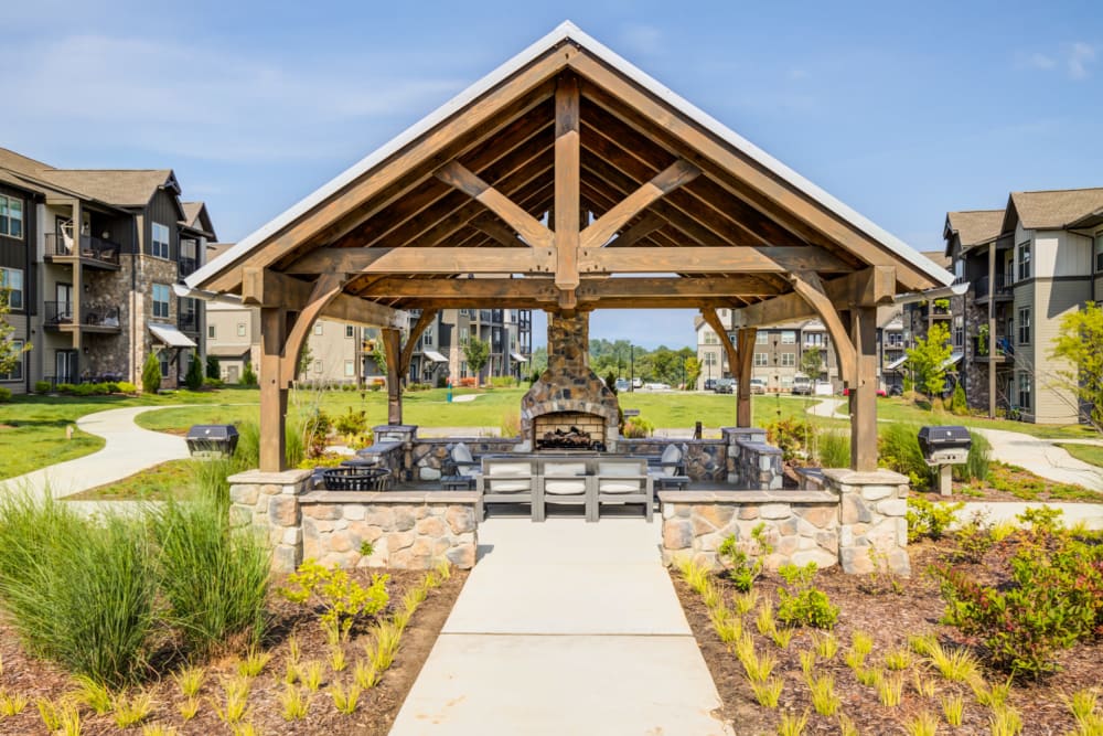 Outdoor firepit and BBQ grilling area at The Holston | Apartments in Weaverville, NC