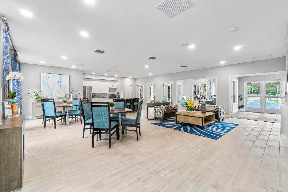 Spacious resident clubhouse with dining area and lounge at Boynton Place Apartments in Boynton Beach, Florida
