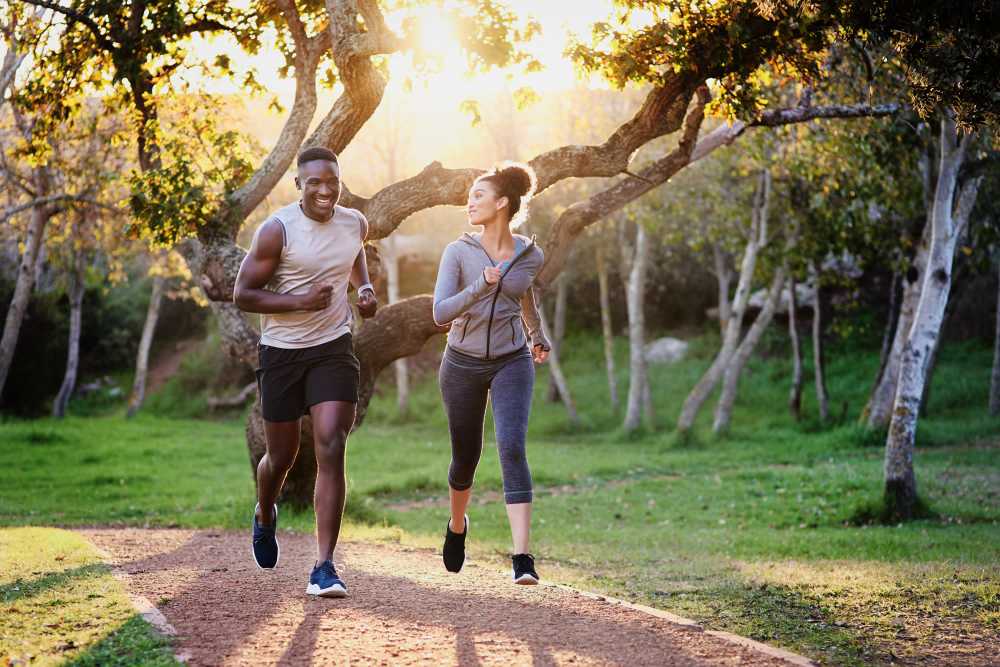 Couple jogging in the park together near Boynton Place Apartments in Boynton Beach, Florida