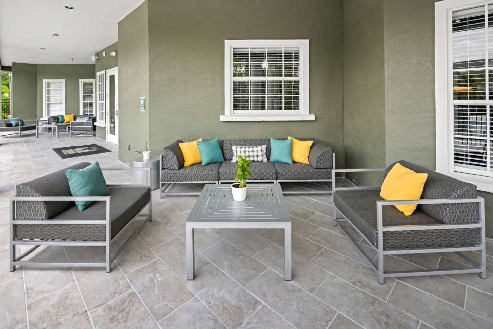 Community patio space with comfortable couches at Pointe Parc at Avalon in Orlando, Florida
