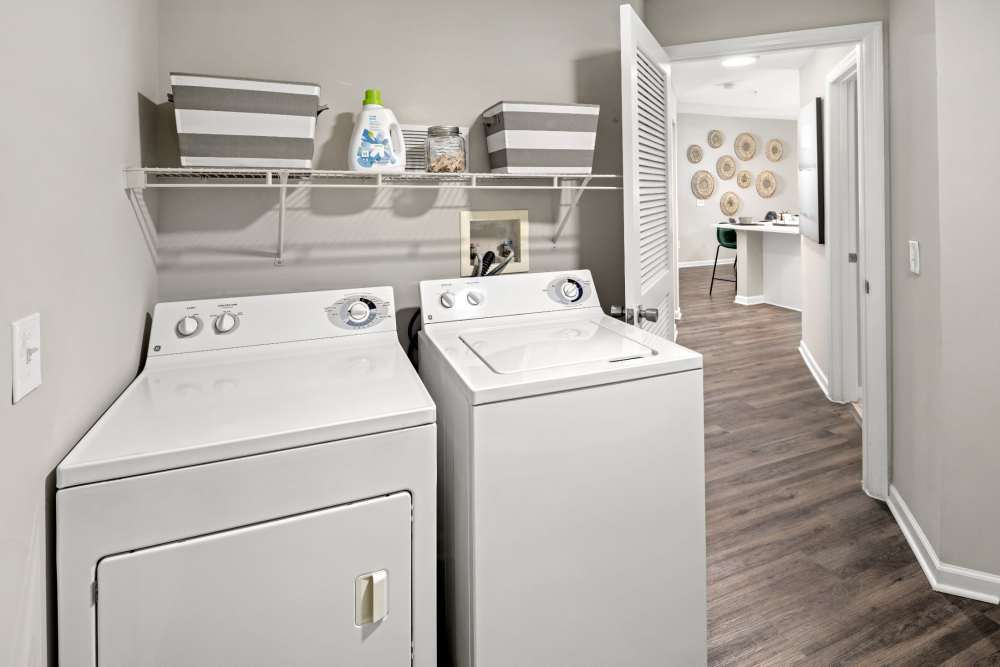 Apartment laundry room with washer and dryer at Pointe Parc at Avalon in Orlando, Florida