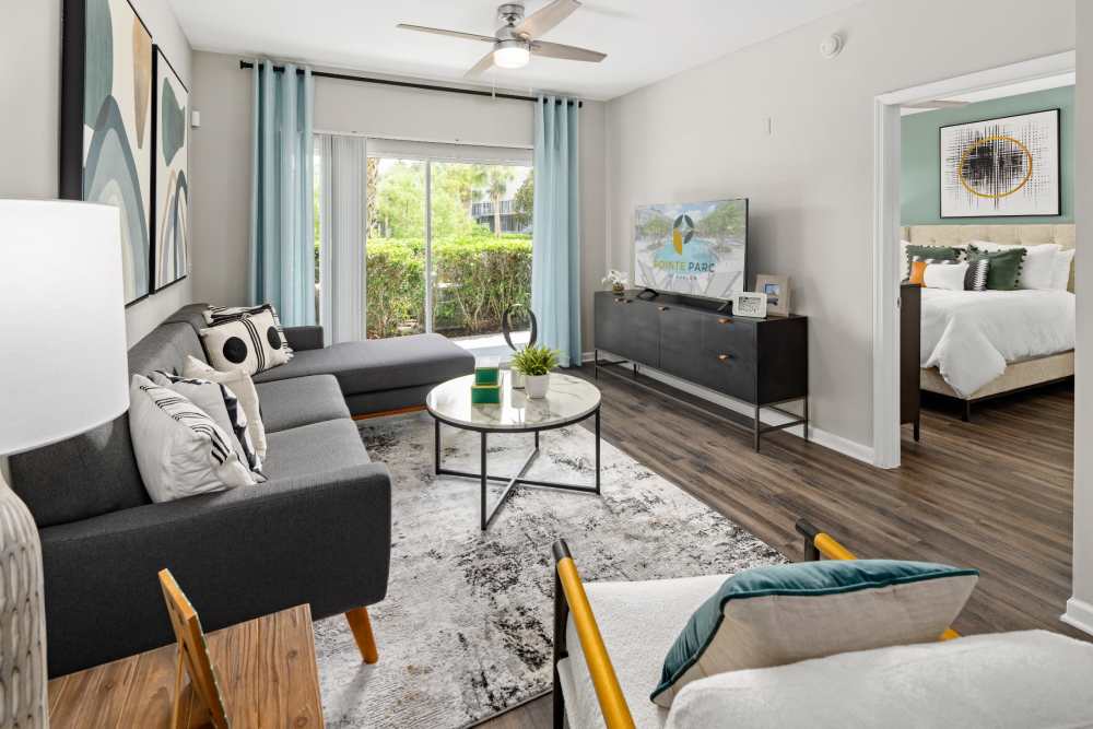 Furnished apartment living room with hardwood floors at Pointe Parc at Avalon in Orlando, Florida