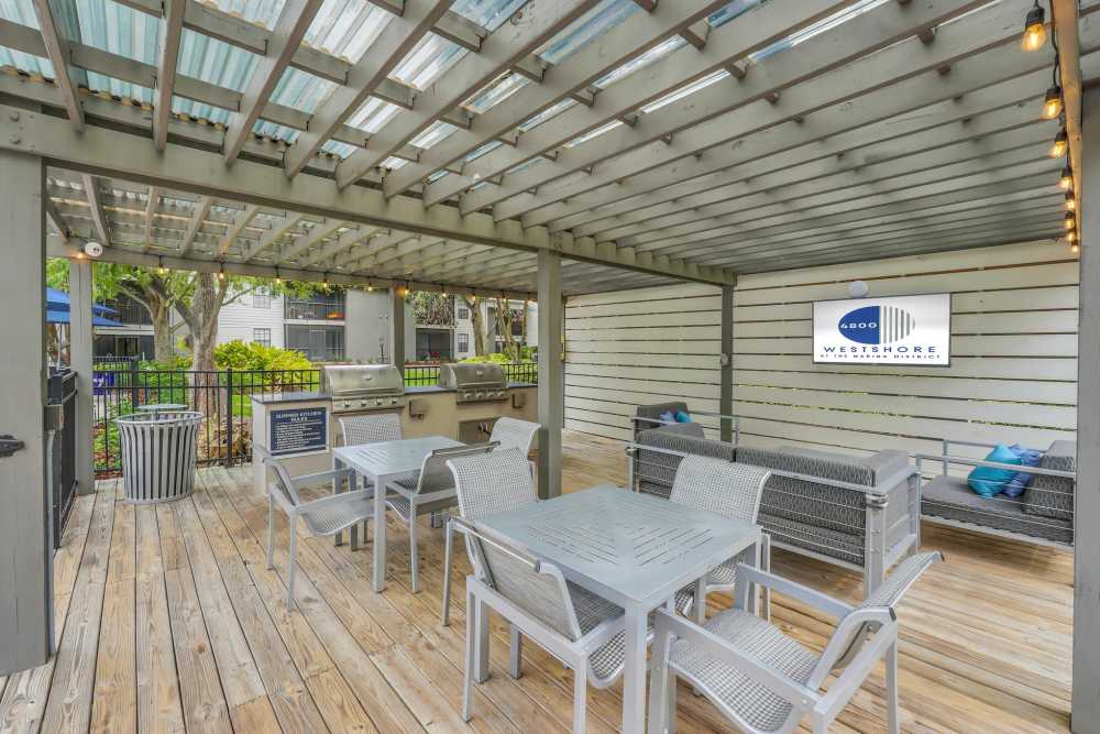 Covered outdoor patio with large television at 4800 Westshore in Tampa, Florida