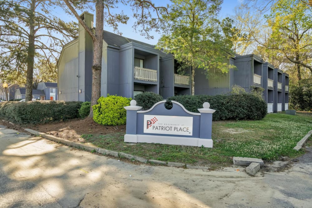 Exterior of an apartment building and the main sign at The Residence at Patriot Place in Columbus, Georgia