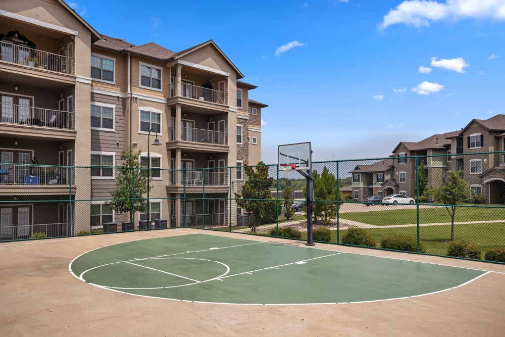 An image showcasing the sports court at Cypress Creek at Joshua Station in Joshua, Texas. The court features vibrant court markings and is bathed in sunlight, ready for residents to enjoy sports and recreation activities in this inviting outdoor space.
