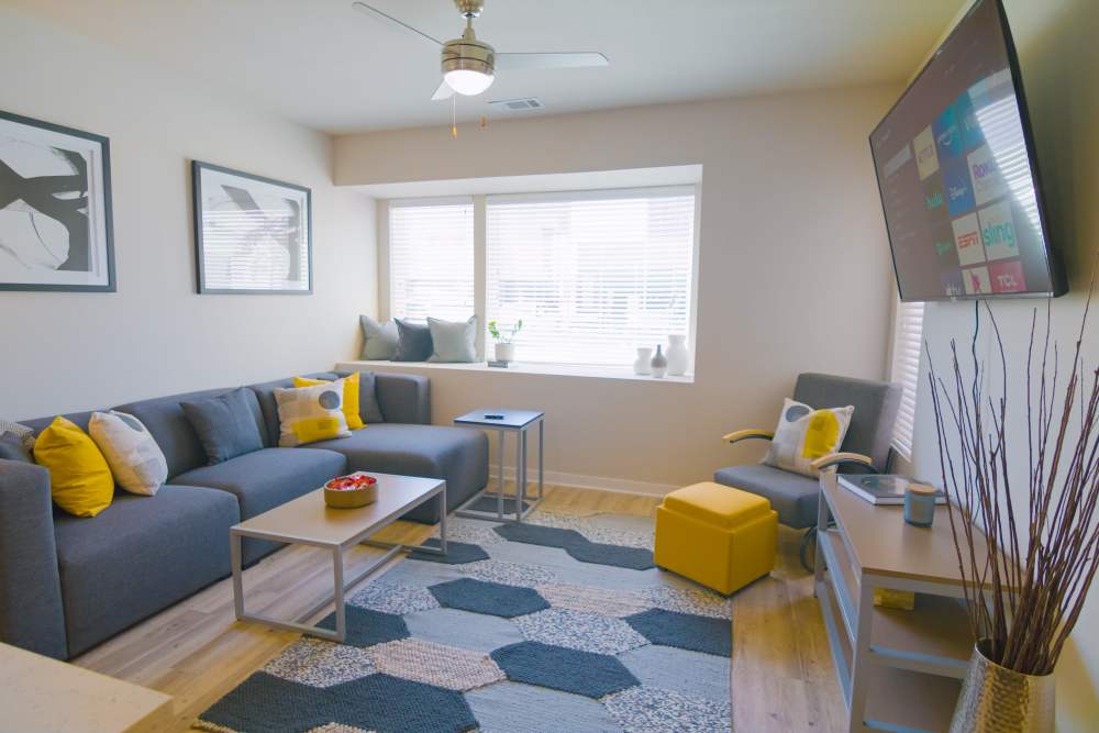 Living room with brightly colored accent pillows at College Town Fayetteville in Fayetteville, Arkansas