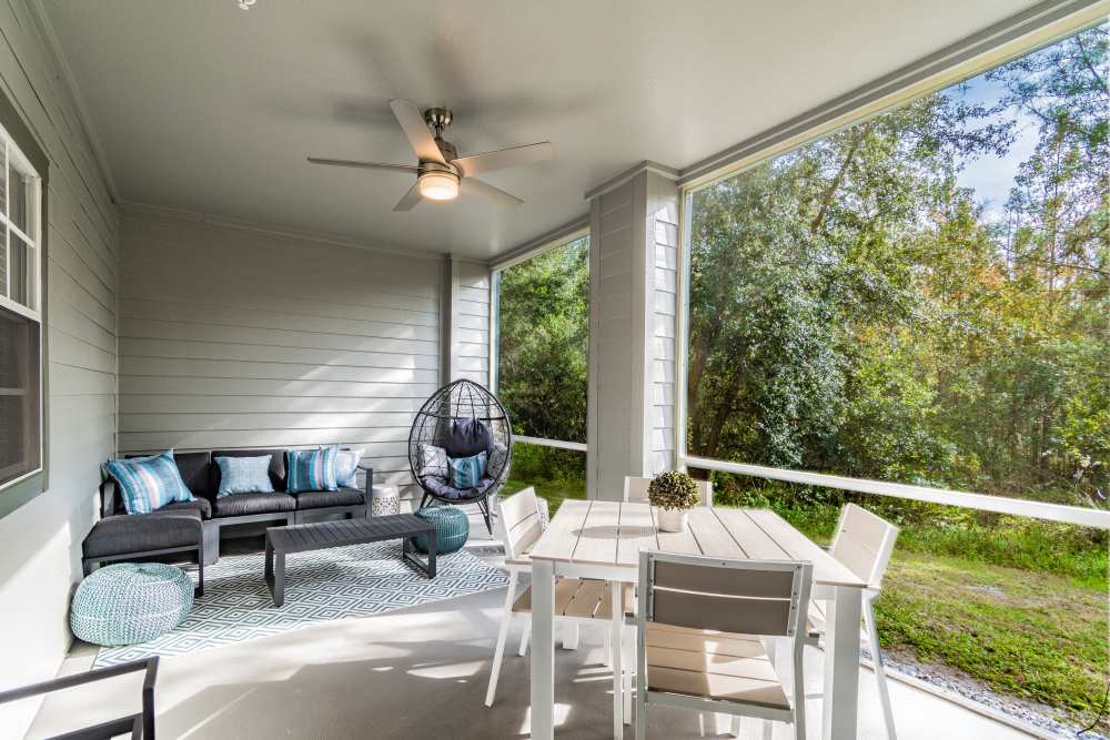 Screened-in patio with ceiling fan and sofa at The Parq at Cross Creek in Tampa, Florida