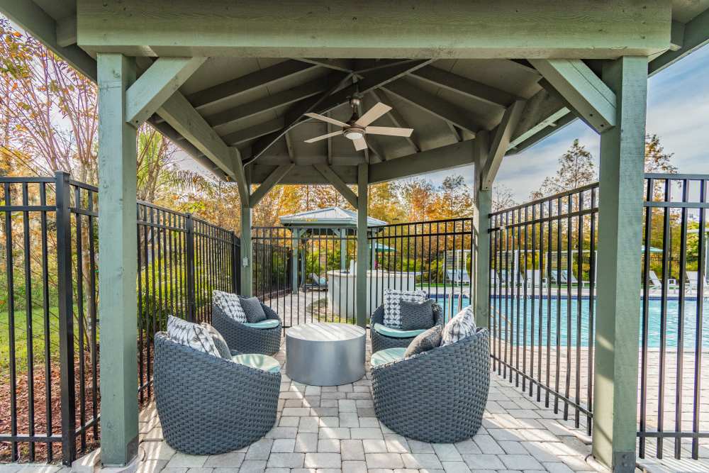 Outdoor covered patio lounge by the pool at The Parq at Cross Creek in Tampa, Florida