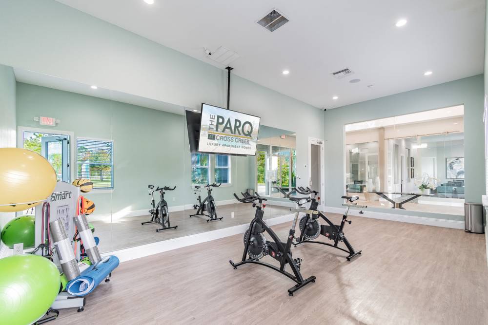 Yoga room with workout equipment and large mirror at The Parq at Cross Creek in Tampa, Florida