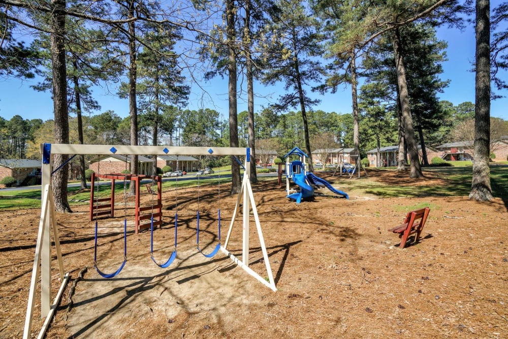 A swing set next to the playground at Rivers Edge Apartments in Jonesboro, Georgia