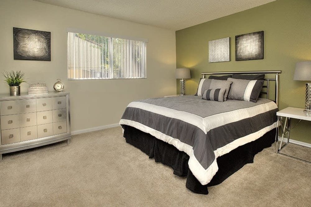 Stylish bedroom featuring a side table at Creekside Gardens in Vacaville, California