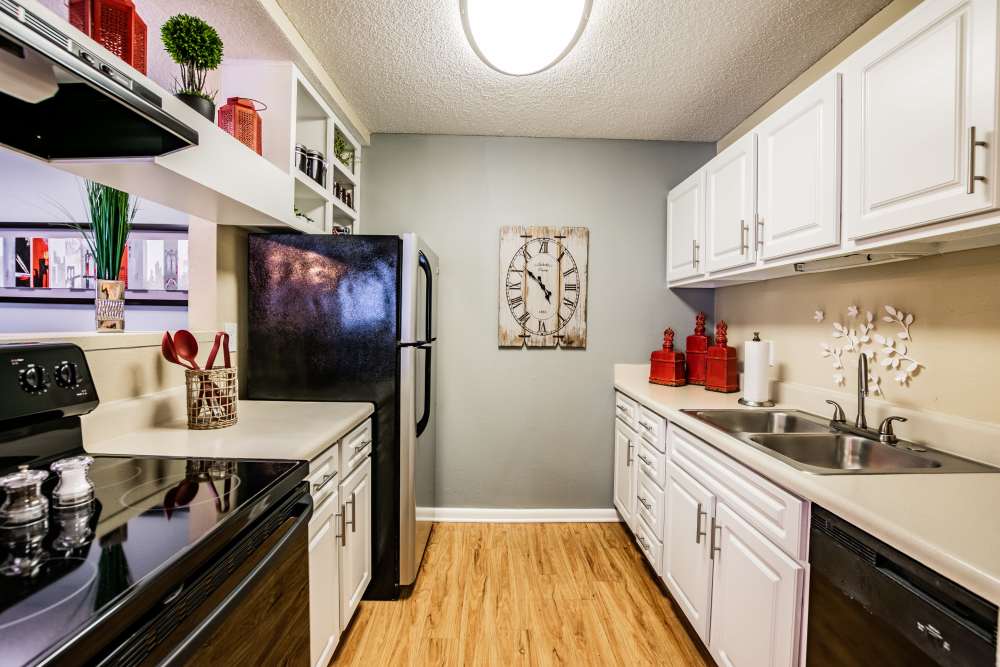 Apartment kitchen with hardwood floors and plenty of counterspace at Waterstone At Carrollwood in Tampa, Florida