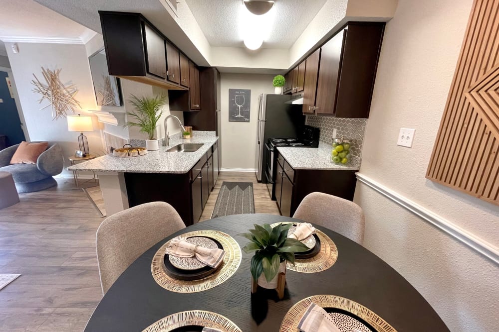 Dining nook and kitchen in a model apartment at The Abbey at Willowbrook in Houston, Texas