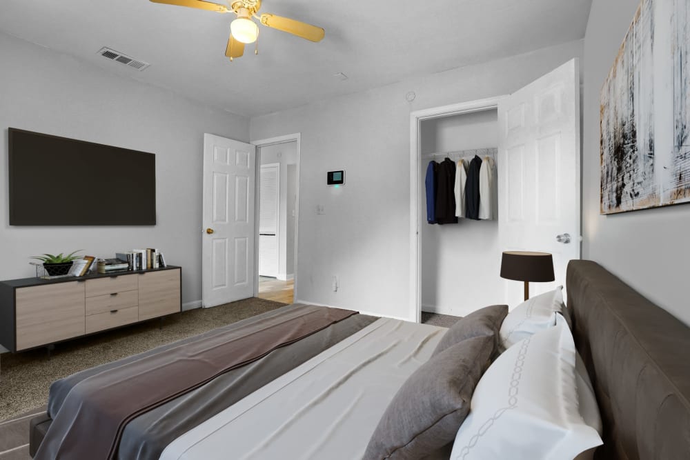 An apartment bedroom with the closet door open at Stanton View Apartments in Atlanta, Georgia
