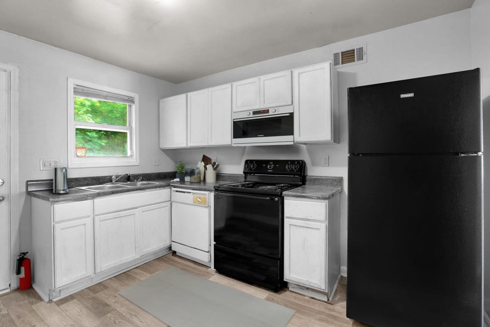 Black appliances and white cabinets in an apartment kitchen at Stanton View Apartments in Atlanta, Georgia
