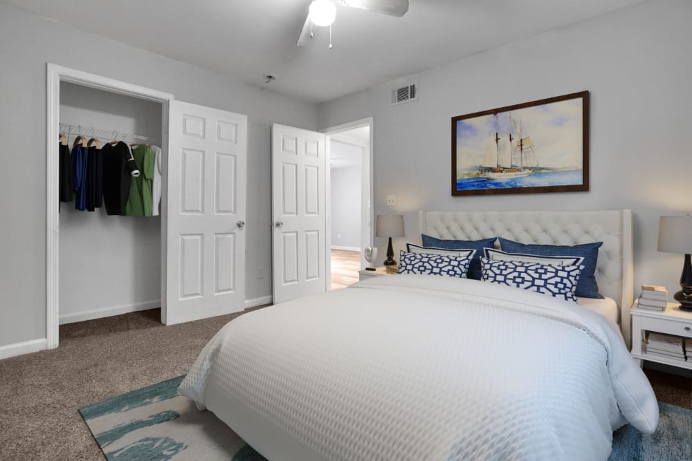 A king sized bed in an apartment bedroom at Stanton View Apartments in Atlanta, Georgia