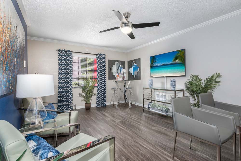 Spacious living room with hardwood flooring and ceiling fan at Barrington Place at Winter Haven in Winter Haven, Florida