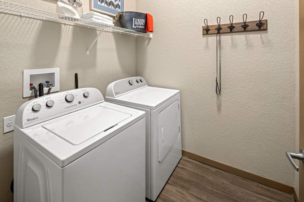 Apartment laundry room with washer and dryer at Station House at Lake Mary in Lake Mary, Florida