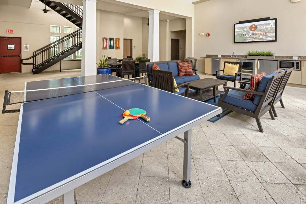 Ping pong table and comfy seating in resident lounge at Station House at Lake Mary in Lake Mary, Florida