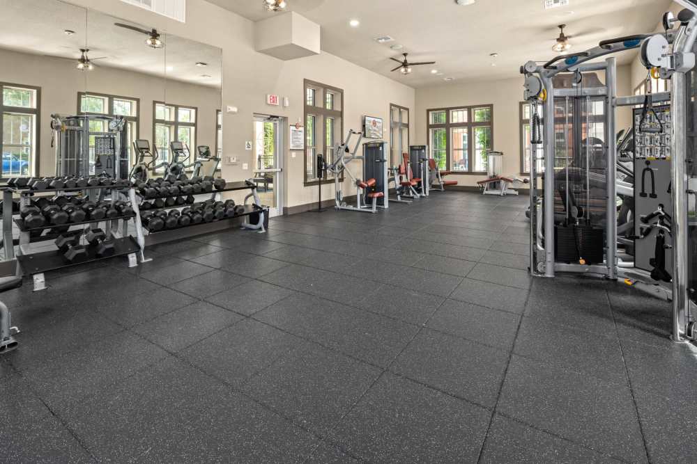 Community fitness center with weight machines at Station House at Lake Mary in Lake Mary, Florida