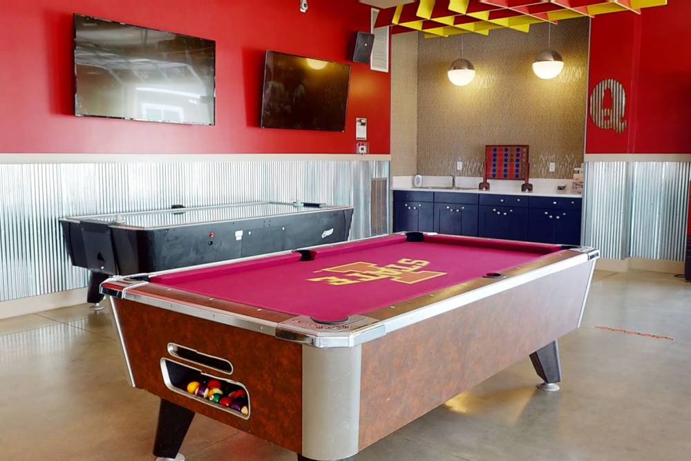 Game room with billiards at The Quarters at Ames in Ames, Iowa