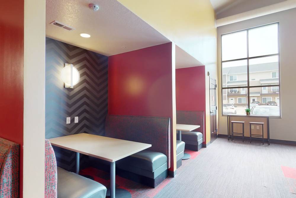 Resident lounge with booths at The Quarters at Ames in Ames, Iowa