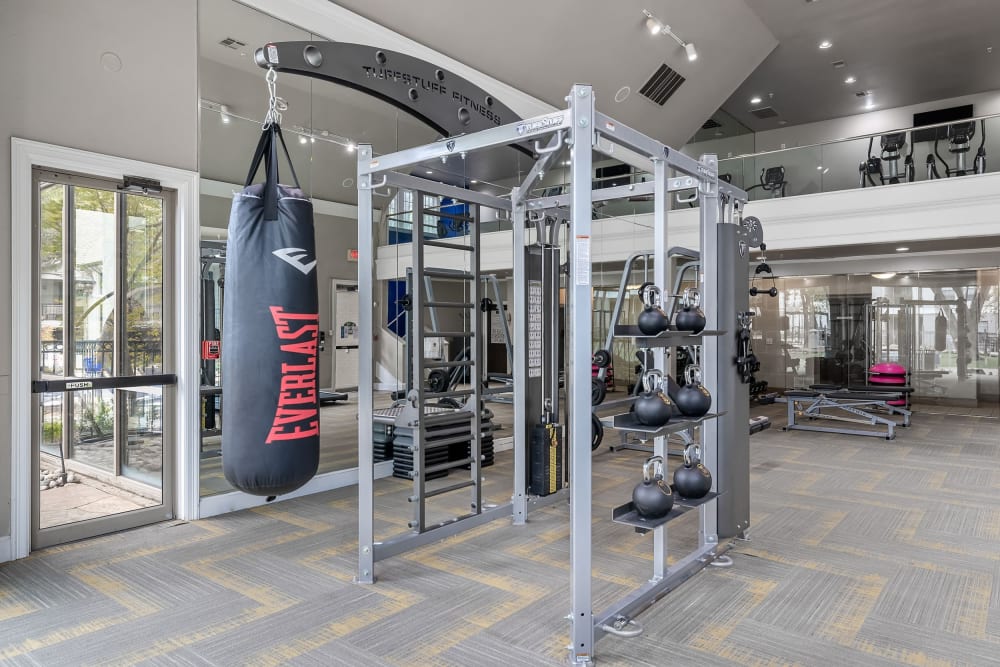 Spacious fitness room with cardio machines and free weights at Marquis at Waterview in Richardson, Texas