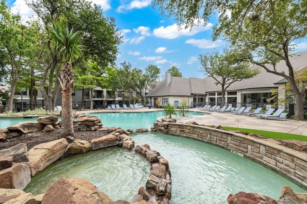 Shallow area of pool sectioned off with rocks at Marquis at Waterview in Richardson, Texas