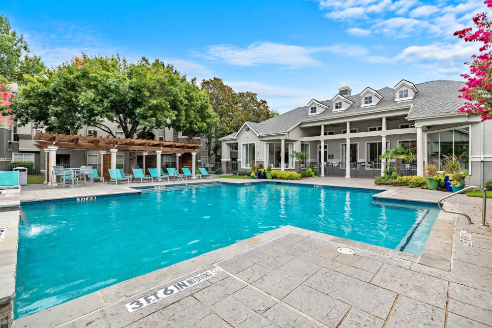 Pool with private cabanas and clubhouse at Marquis at Stonegate in Fort Worth, Texas