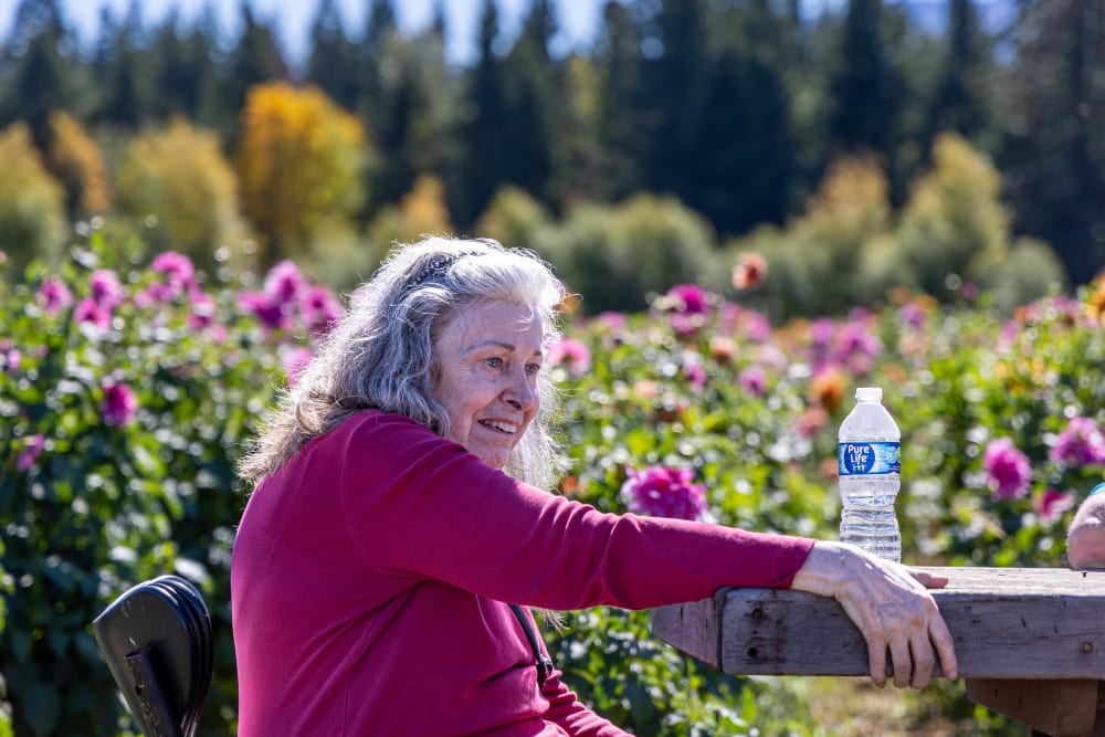 Elderly woman in pink jacket enjoying outdoors at Cherry Park Plaza in Troutdale, Oregon