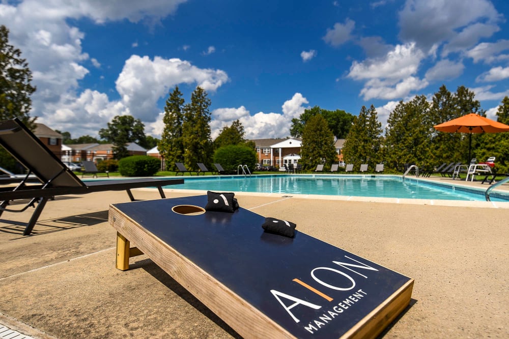 Outdoor swimming pool and cornhole at Parc at West Point, North Wales, Pennsylvania