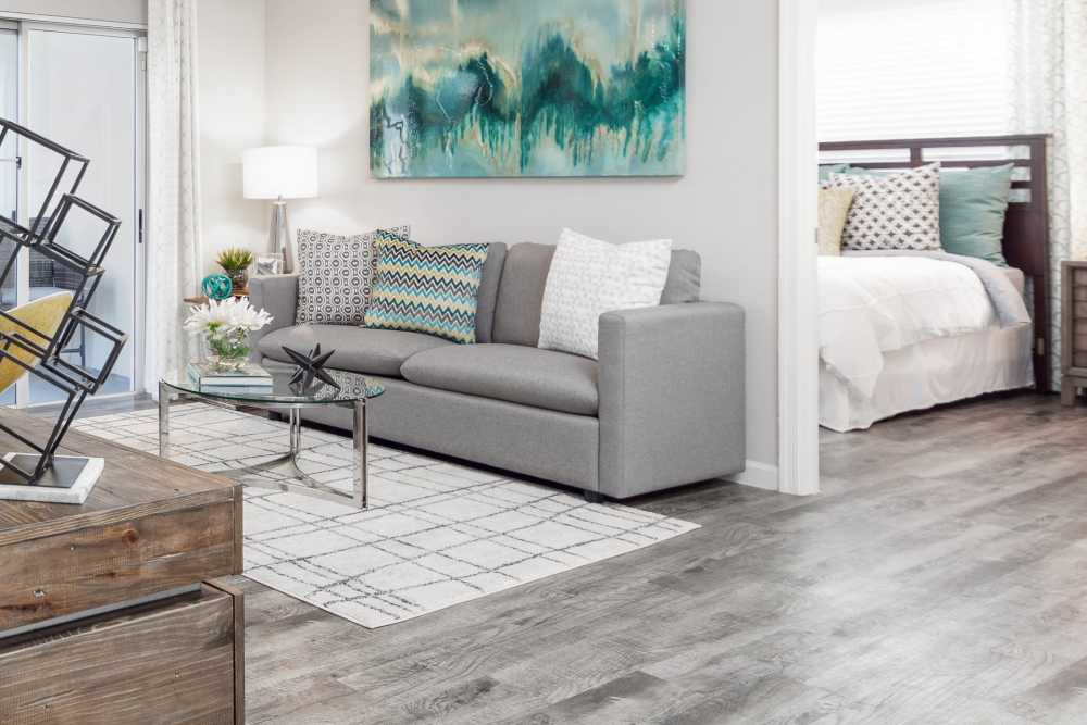 Apartment living room with hardwood floors, sofa, and coffee table at Nova Central Apartments in Davie, Florida