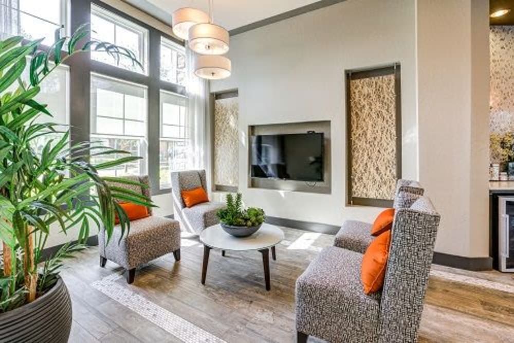 Resident lounge with electric fireplace at Addison at Tampa Oaks in Temple Terrace, Florida