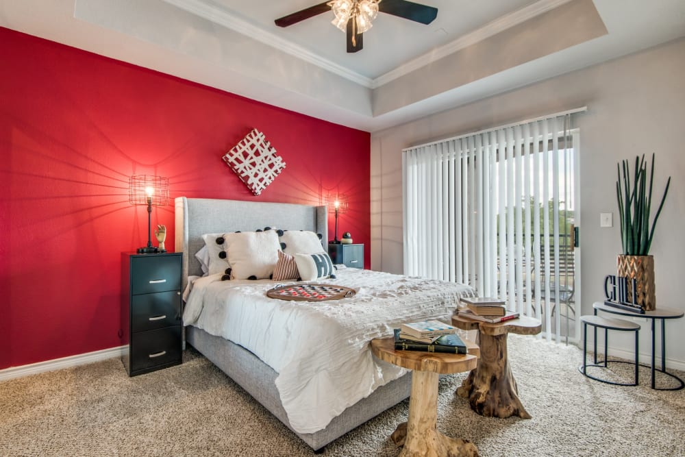 Model bedroom with red accents at The Anthony at Canyon Springs in San Antonio, Texas
