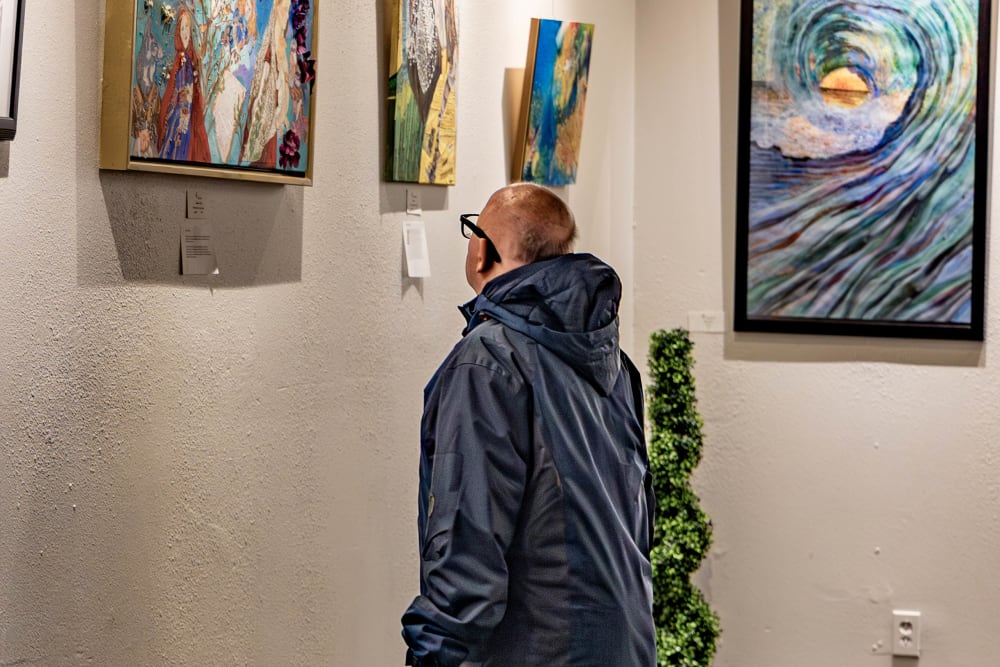 An Elderly looking at some paintings at  Cherry Park Plaza in Troutdale, Oregon