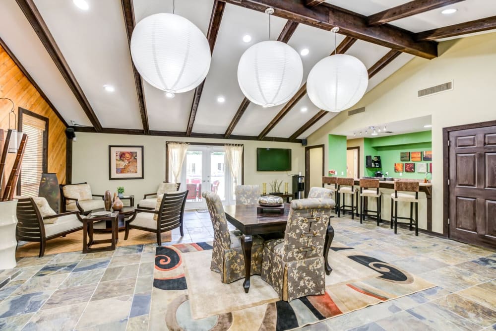 Trendy community lounge with hanging light fixtures at Stone Creek in Tampa, Florida