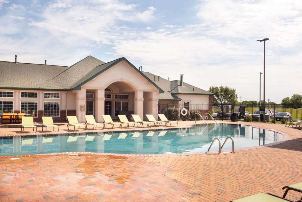 Luxury pool with poolside seating at The Quarters at Lincoln in Lincoln, Nebraska