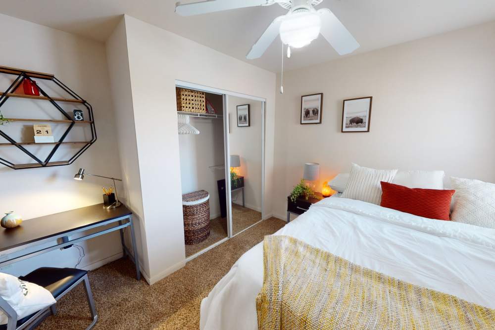 Bedroom with ceiling fan and closet at The Quarters at Lincoln in Lincoln, Nebraska