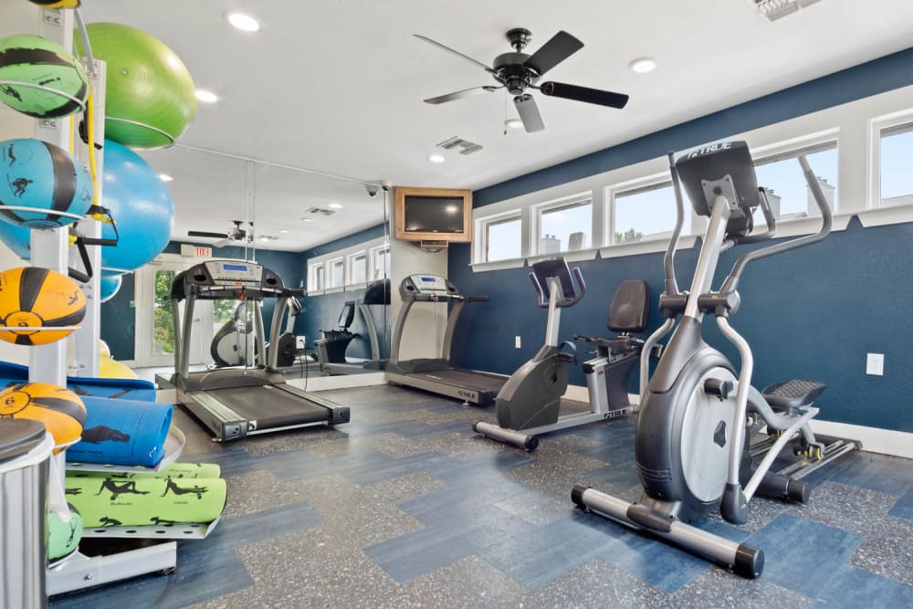 Modern gym fitness room with treadmills at The Carling on Frankford in Carrollton, Texas