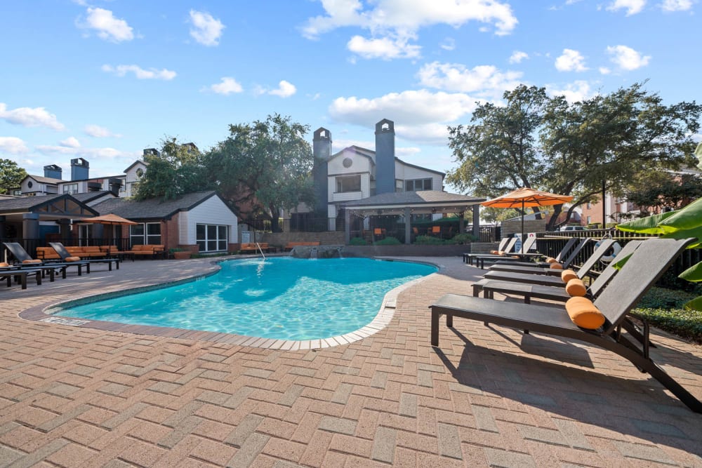Pool with lounge chairs at Somerset in Lewisville, Texas
