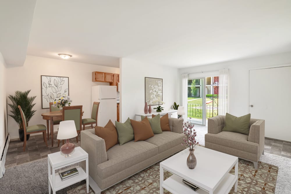 Living Room with patio accessat Edgewater Gardens Apartment Homes in Long Branch, New Jersey