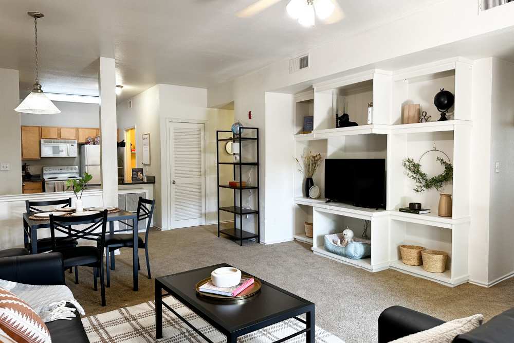 Spacious living room with built-in entertainment center at The Quarters at Lawrence in Lawrence, Kansas